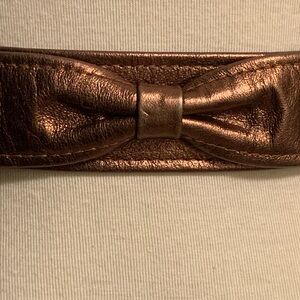 KEMESTRY BRONZE METALLIC LEATHER BELT WOTH BOW DETAIL